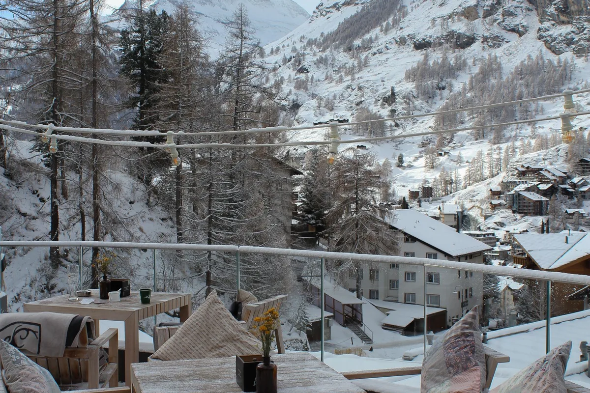 Outdoor seating with snowy mountain views (representative image)