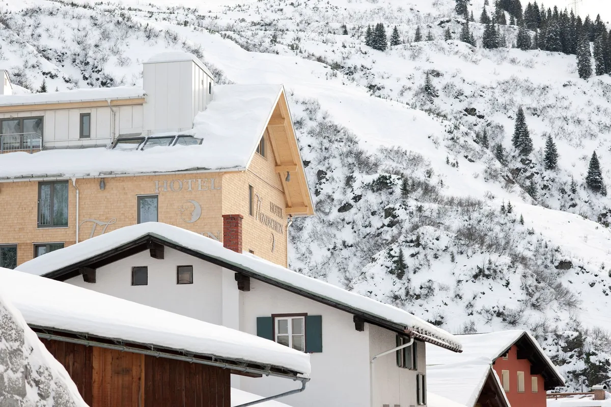 Snow-covered village beneath mountain slopes (representative image)